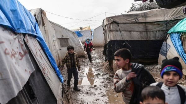 Refugee children walk between tents at a camp near the Turkish border in Bab al-Salama, near Azaz, northern Syria. (AFP/Bulent Kilic)