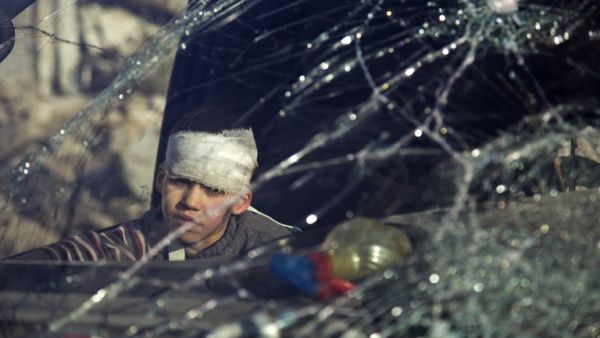 A wounded by sits inside an ambulance as Syrian rebels and their families gather at the rebel-held al-Amiriyah neighborhood of Aleppo as they wait to be evacuated on December 15, 2016. (AFP/Karam al-Masri)