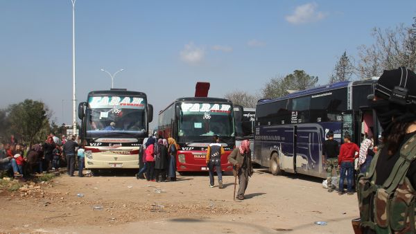 Buses carrying civilians from two government-held villages in Idlib wait in Aleppo, before the explosion. (AFP/Omar Haj Kadour)