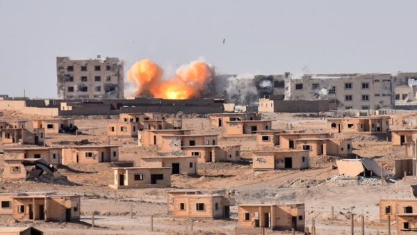 Smoke rises from buildings in the area of Bughayliyah, on the northern outskirts of Deir Ezzor on September 13, 2017, as Syrian forces advance during their ongoing battle against ISIS. (George Ourfalian/AFP)