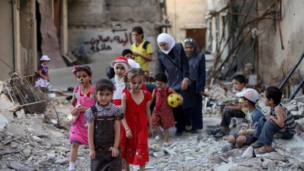Syrian children walk amid destruction on the outskirts of Damascus in Eid Al Fitr. (Amer Al Mohibany/ AFP)