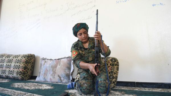 Yazidi fighter Heza prepares her rifle in an abandoned home used as a base on the eastern outskirts of Raqa on July 18, 2017. (AFP)