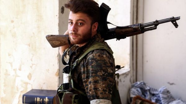 A Syrian Democratic Forces fighter in the suburb of al-Rumaniya on the western outskirts of Raqqa on June 27, 2017 after the area was seized from Daesh. (Delil Souleiman/AFP)