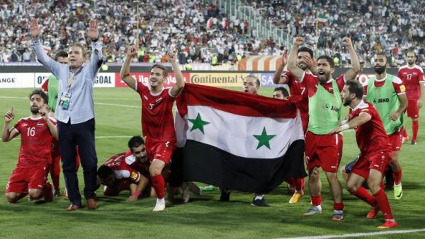 Syria's players celebrate at the end of their FIFA World Cup 2018 qualification football match against Iran on September 5, 2017. (Atta Kenare/AFP)