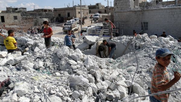 Syrians check a damaged house, reportedly hit by US-led coalition air strikes. (AFP/Sami Ali) 