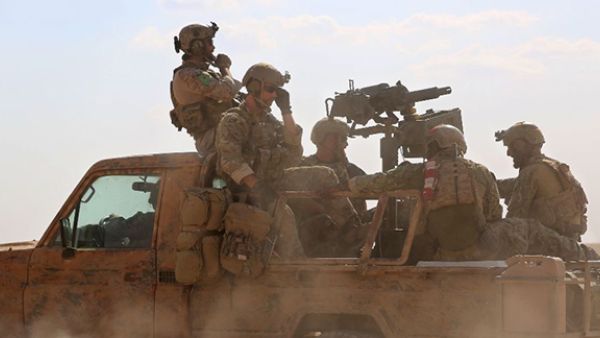 Armed men in uniform identified by Syrian Democratic Forces as US special operations personnel ride in a pickup truck in the village of Fatisah in the northern Syrian province of Raqa on May 25, 2016 (AFP/Delil Souleiman)