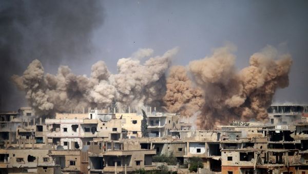 Smoke rises from buildings following a reported air strike on a rebel-held area in the southern Syrian city of Daraa, on June 14, 2017. (Mohamad Abazeed/AFP)