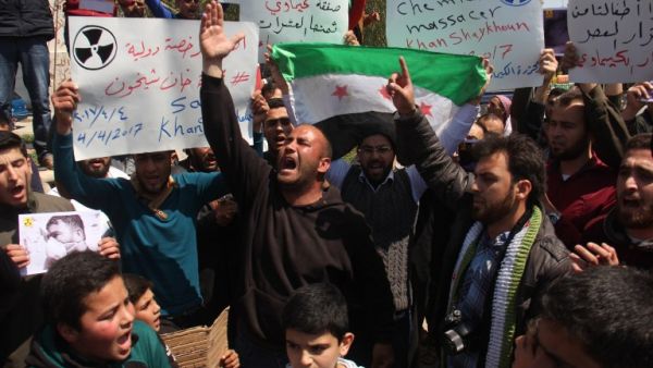 Syrian residents of Khan Sheikhun hold placards and pictures on April 7, 2017 during a protest condemning a suspected chemical weapons attack on their town earlier this week that killed at least 86 people, among them 30 children. (AFP/Omar Haj Kadour) Syrian residents of Khan Sheikhun hold placards and pictures on April 7, 2017 during a protest condemning a suspected chemical weapons attack on their town earlier this week that killed at least 86 people, among them 30 children. (AFP/Omar Haj Kadour)