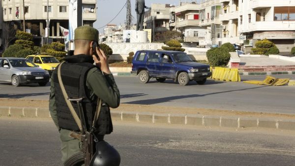 A Syrian government forces member mans a checkpoint at the President square in Homs, the country's third city, on February 25, 2017 as security measures were tightened following a number of suicide attacks. (AFP/Stringer)