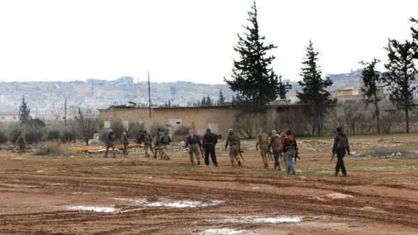 Turkey backed Syrian opposition fighters walk with their weapons in the northeastern outskirts of the Syrian town of al-Bab, Daesh's last stronghold in Syria's Aleppo's province, on February 15, 2017. (AFP/Rafat Ahmed)