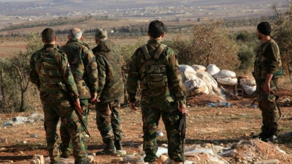 Syrian regime security forces overlook the Hama province. (AFP/File)
