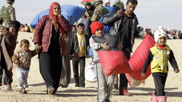 A Syrian refugee family crosses at the Hadalat border into Jordan. (Khalil Mazraawi / AFP)