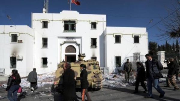 People walk past a government building in Kef, Tunisia. (AFP/File)