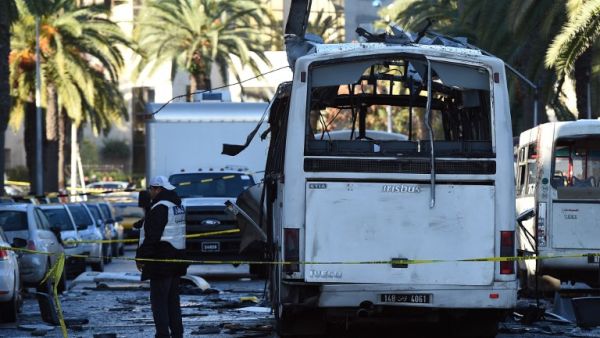 Tunisian police inspect the bombed bus on November 24, 2015. (AFP/Fethi Belaid)
