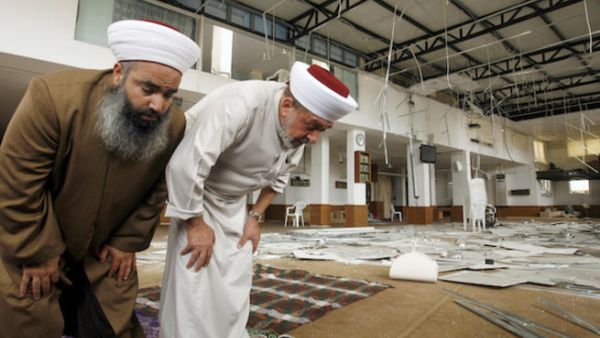  Sidon's mufti Sheikh Salim Sousan (R) prays inside the Bilal bin Rabah mosque, in the Abra district of the southern city of Sidon on June 29, 2013 (Source: AFP/MAHMOUD ZAYYAT)