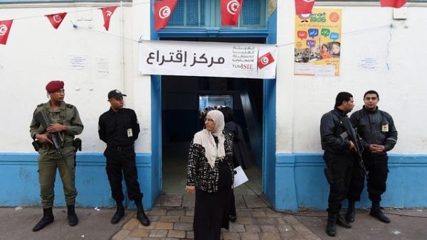 A Tunisian woman exits a Tunis polling station after voting in the first round of presidential elections on November 23, 2014. (AFP/File)