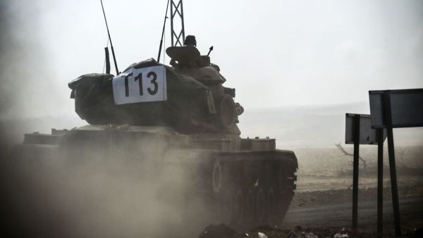 A Turkish army tank enters Syria last week (AFP/Bulent Kilic)
