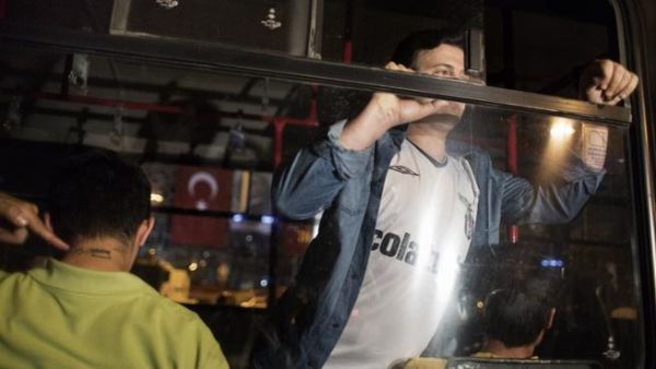 Men detained for emulating Turkish choreographer Erdem Gunduz for standing on Taksim square in a lone protest are seen arrested inside a truck used by the Turkish police June 18 (Marco Longari / AFP)