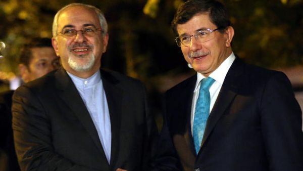 Turkish Foreign Minister Ahmet Davutoglu (R) shakes hands with his Iranian counterpart Javad Zarif prior to a meeting in Ankara. (Image credit: AFP) 