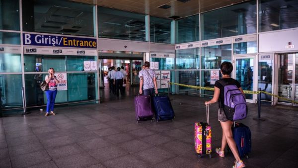 Passengers enter the Ataturk airport International arrival terminal a day after a suicide bombing and gun attack targeted Istanbul's airport, killing at least 36 people.   (AFP/Ozan Kose)
