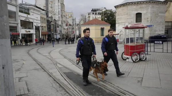 Turkish police patrol with a police dog a day after a suicide bomb attack on Istiklal Street, a major shopping and tourist district, in central Istanbul, on March 20, 2016. (AFP/Yasin Akgul)