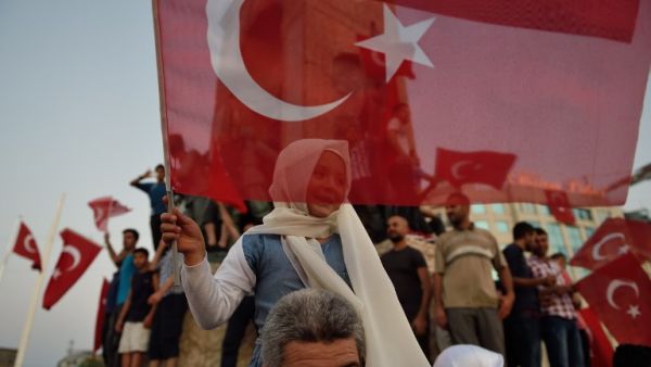 A child waves a Turkish flag in Istanbul on July 16, 2016 during a demonstration in support to Turkish president. (AFP/Daniel Mihailescieu