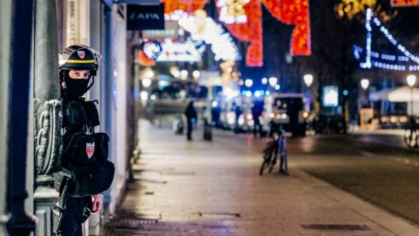 A French police officer stands guard near the scene of a shooting on December 11, 2018 in Strasbourg, eastern France. (Abdesslam MIRDASS / AFP)