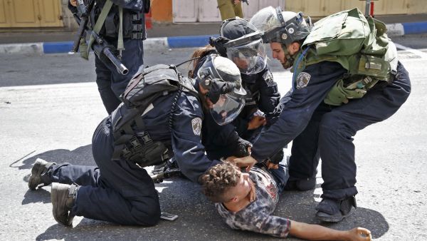 Israeli forces arrest a Palestinian youth during clashes between demonstrators and security forces in the city of Hebron in the Israeli-occupied West Bank. (AFP) 