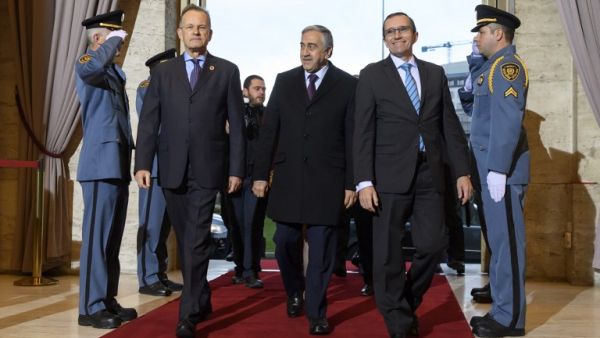 Turkish Cypriot leader Mustafa Akinci (C) is welcomed by Director-General of the United Nations Office at Geneva Michael Moller (L) and Special Adviser of the Secretary-General on Cyprus Espen Barth Eide (R) at UN-sponsored Cyprus peace talks on January 9, 2017 in Geneva. (AFP/Fabrice Coffrini)