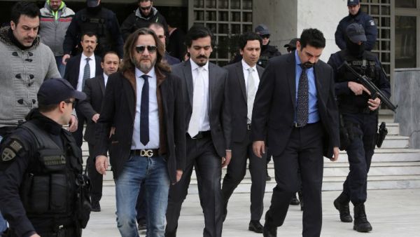 Turkish officers are escorted by Greek special police forces as they leave the Greek Supreme Court in Athens, after a hearing concerning a possible extradition of the officers over July's failed coup in Turkey, on January 23, 2017 in Athens. (AFP/Angelos Tzortzinis)