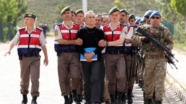 Turkish Gendarmerie escort defendants Akin Ozturk (3L) and others involved in last July’s attempted coup in Turkey as they leave the prison where they are being held, ahead of their trial in Ankara, on May 22, 2017. (Adem Altan/AFP)