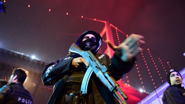Turkish police officers stand guard on the site of an armed attack at the Reina nightclub in Istanbul on January 1, 2017. (AFP Photo/Yasin Akgul)
