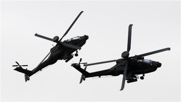 Helicopters of the UAE armed forces fly during a military show at the opening of the International Defense Exhibition and Conference (IDEX) at the Abu Dhabi National Exhibition Centre in the Emirati capital on February 22, 2015. (AFP)