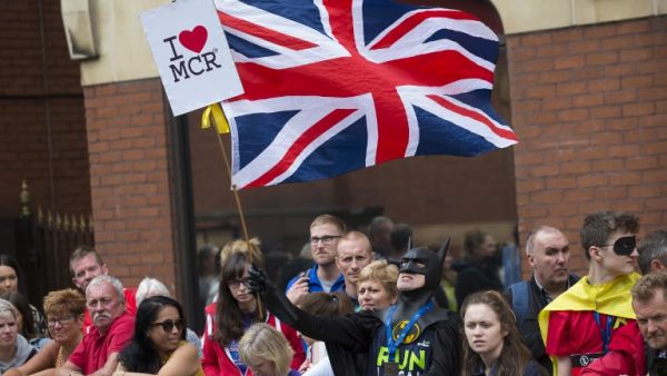 A man dressed as Batman waves a Union flag at the start of the Great Manchester Run in Manchester, north west England on May 28, 2017. (Jon Super/AFP)