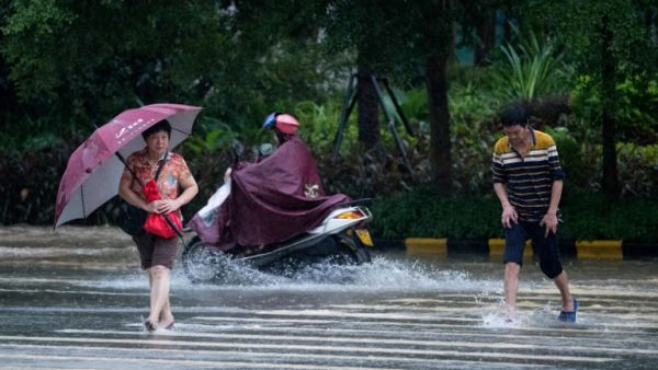 People wade through flooded streets a day after super Typhoon Mangkhut in Yangjiang, in Guangdong province on September 17, 2018. (AFP/ File)