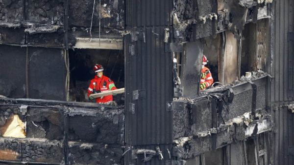 Members of the emergency services work on the middle floors of the charred remnains of the Grenfell Tower block in Kensington, west London, on June 17, 2017, follwing the June 14 fire at the residential building. (Tolga Akmen/AFP)