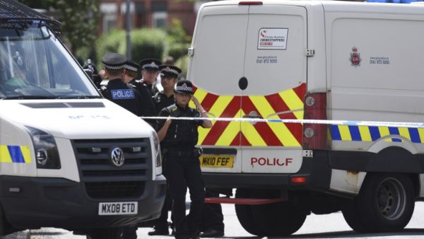 Police officers work at the scene near a property they entered in the Moss Side area of Manchester on May 27, 2017 during an operation relating to last week's terror attack in the city. (Oli Scarff/AFP)