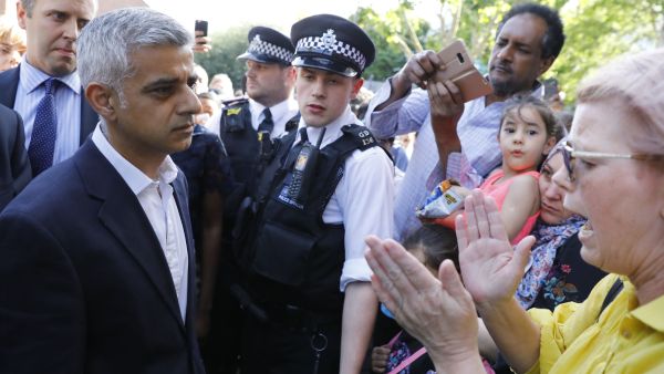 Prime Minister Theresa May and London Mayor Sadiq Khan visited the scene of the deadly blaze on Thursday, promising a full investigation into the catastrophe. (AFP)