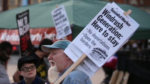 Supporters carry placards at the tail-end of a Windrush generation solidarity protest in Brixton, London on April 20, 2018. (AFP/ File Photo)