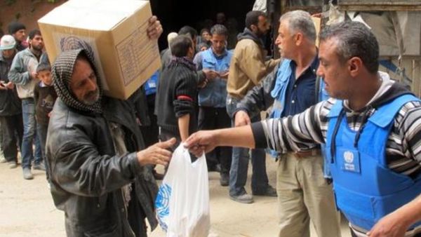 Displaced people from the Yarmouk Palestinian refugee camp queuing to receive aid from UNRWA in Yalda, south of the Syrian capital, Damascus in 2015. (AFP/File)
