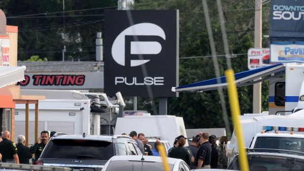 Orlando police officers seen outside of Pulse nightclub after a fatal shooting and hostage situation on June 12, 2016 in Orlando, Florida. (AFP/Gerardo Mora)