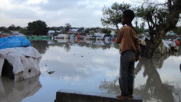 A Somalian internally displaced child looks at a flooded section of a camp in Mogadishu, following heavy rain and flash floods. (AFP/File Photo)