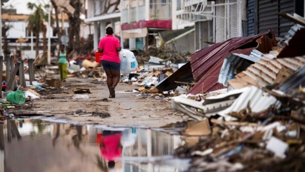 A woman walks on a street in Marigot, on September 11, 2017 on the French Caribbean island of Saint-Martin after it was hit by Hurricane Irma. (Martin Bureau/AFP)