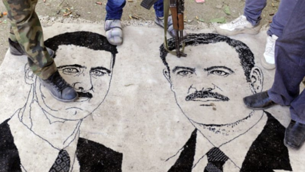 Assad and his late Father /AFP