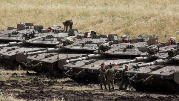 Israeli Merkava tanks are seen in a deployment area near the Syrian border in the Israel-annexed Golan Heights on May 10, 2018 (AFP)