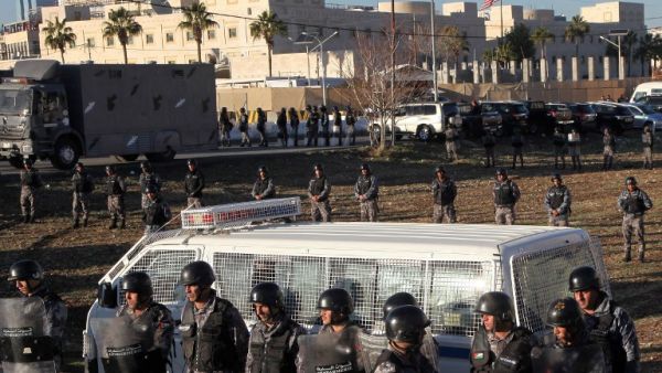 Jordanian police stand guard in front of the American embassy in Amman during a demonstration against the US president's decision to recognise Jerusalem as the capital of Israel, on December 8, 2017 (Ahmad Abdo/AFP)