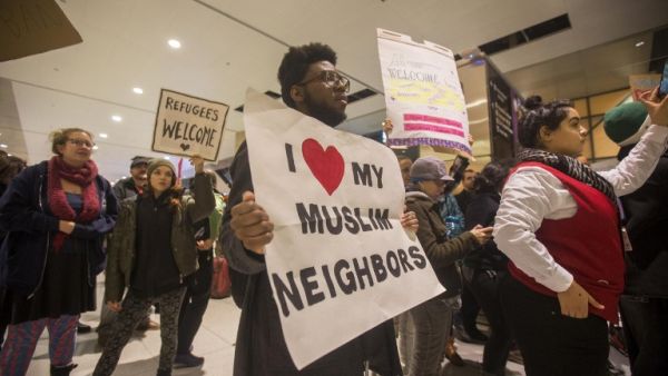 A protestor demonstrates against the new ban on immigration issued by President Donald Trump at Logan International Airport, Boston on January 28, 2017. (AFP/Scott Eisen) A protestor demonstrates against the new ban on immigration issued by President Donald Trump at Logan International Airport, Boston on January 28, 2017. (AFP/Scott Eisen)