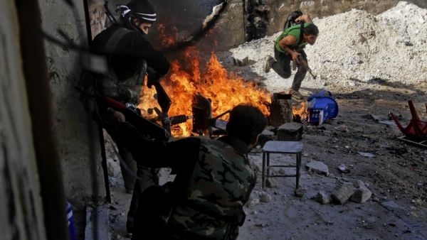 Syrian rebels of the Halab al-Shabah battalion under Al-Tawhid brigade take position during clashes with regime forces in Al-Amariya district of the northern city of Aleppo. (AFP/File)

