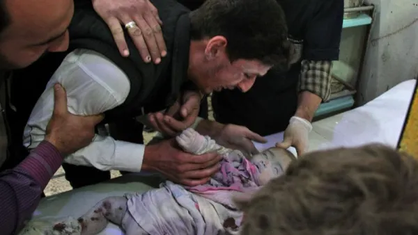 A Syrian cries over body of a lifeless baby on November 2, 2017 in the Eastern Ghouta region outside Damascus. (AFP/ File Photo)