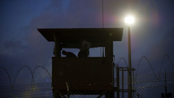 In this March 30, 2010 file photo reviewed by US military officials, a member of the US military mans the guard post before sunrise at Camp Delta, part of the US Detention Center in Guantanamo Bay, Cuba. (AFP/Paul J. Richards)